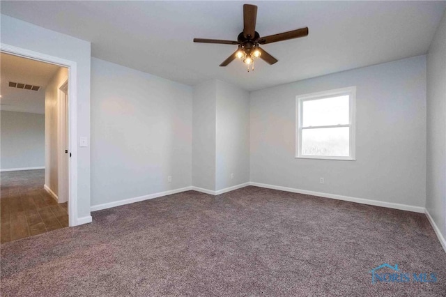 unfurnished room featuring carpet floors, visible vents, baseboards, and ceiling fan