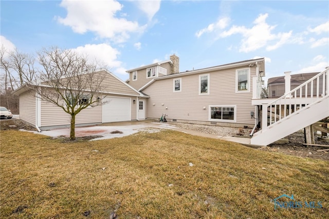 back of house with stairs, a chimney, concrete driveway, and a yard