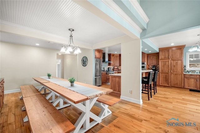 dining room featuring baseboards, light wood-style flooring, beam ceiling, and an inviting chandelier