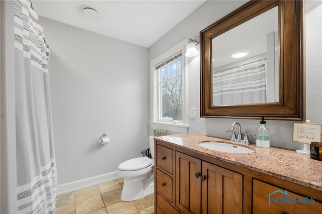 full bathroom featuring toilet, tile patterned floors, vanity, and baseboards