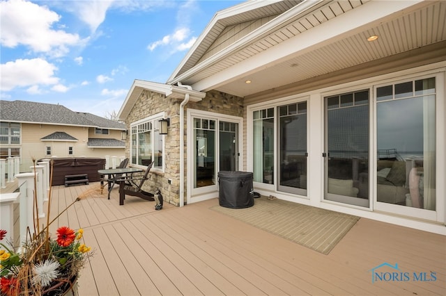 wooden terrace featuring a hot tub