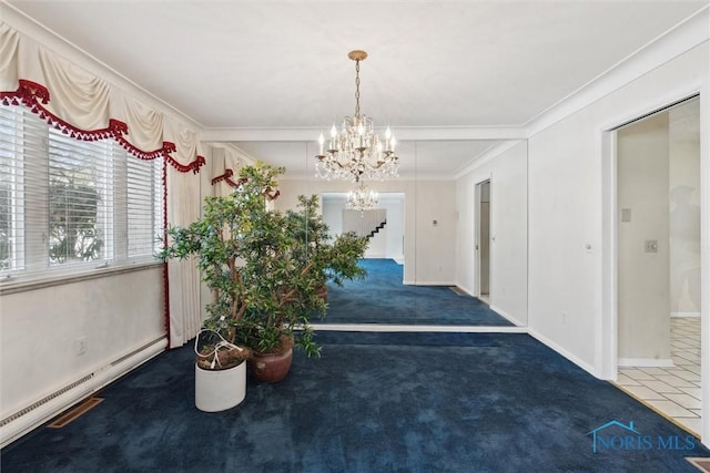 hallway with carpet, a notable chandelier, baseboard heating, ornamental molding, and baseboards