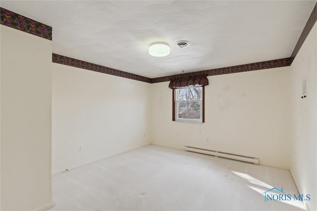 unfurnished room featuring visible vents, baseboard heating, and carpet flooring