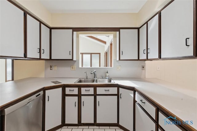 kitchen with white cabinets, light countertops, dishwasher, and a sink