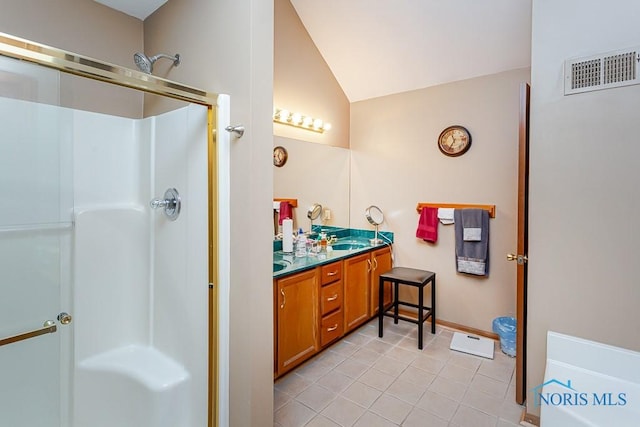 bathroom with double vanity, a stall shower, visible vents, lofted ceiling, and a sink