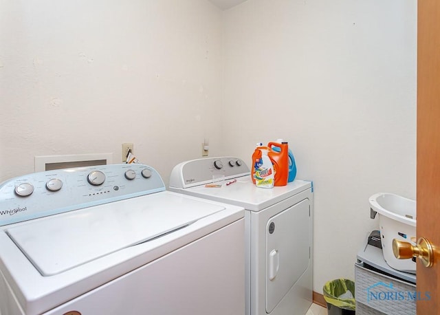 clothes washing area with laundry area and washer and clothes dryer