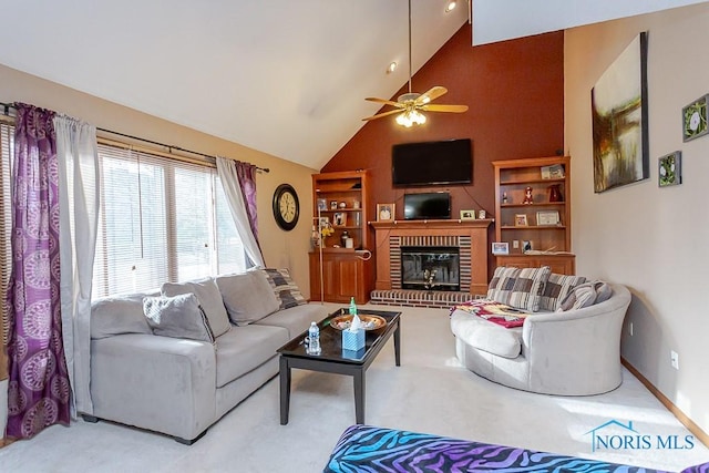 living area with carpet floors, a fireplace, ceiling fan, high vaulted ceiling, and baseboards