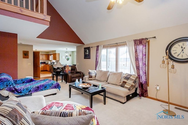 living area featuring high vaulted ceiling, light colored carpet, a ceiling fan, baseboards, and visible vents