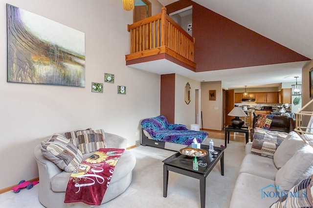 living area with light carpet, high vaulted ceiling, and baseboards