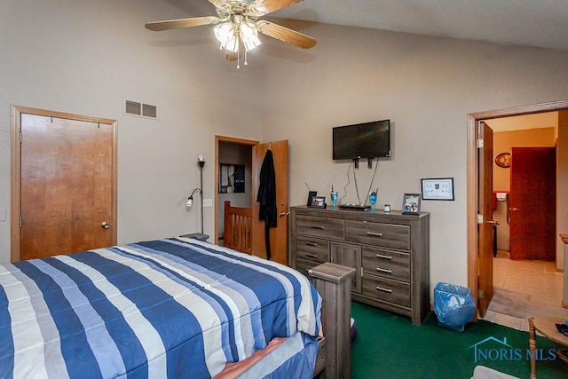 bedroom with carpet, visible vents, vaulted ceiling, and ceiling fan