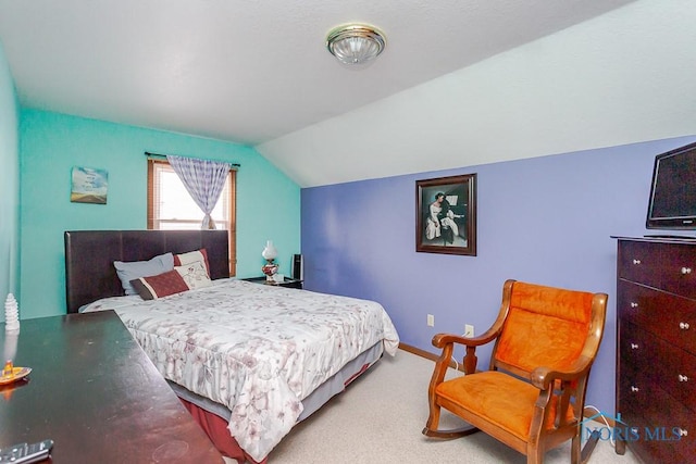 bedroom featuring carpet, baseboards, and vaulted ceiling