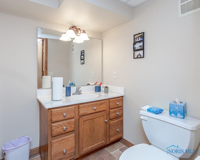 bathroom featuring toilet, vanity, visible vents, and a notable chandelier