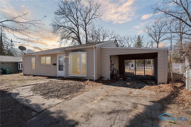 view of front of house featuring aphalt driveway and a carport