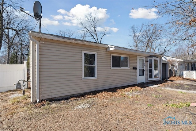 view of front of home featuring fence