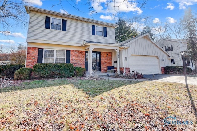 view of front of house with concrete driveway, brick siding, a garage, and a front yard