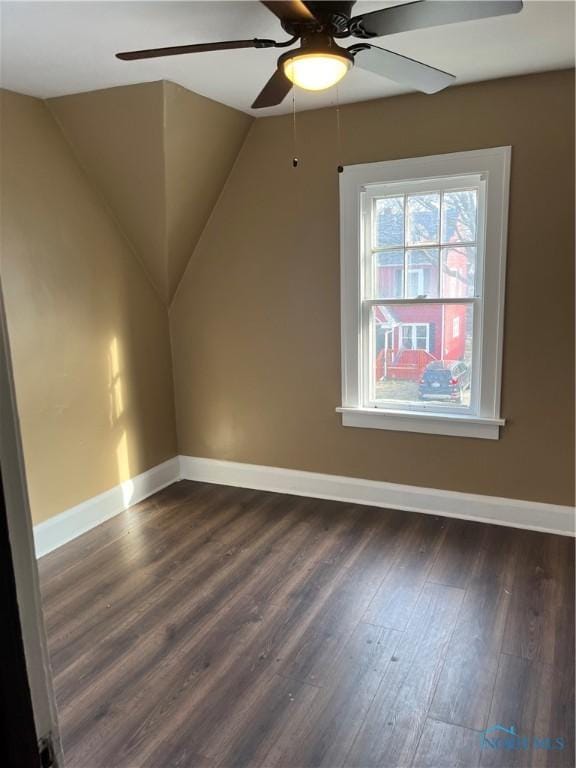 bonus room with baseboards, lofted ceiling, a ceiling fan, and dark wood finished floors