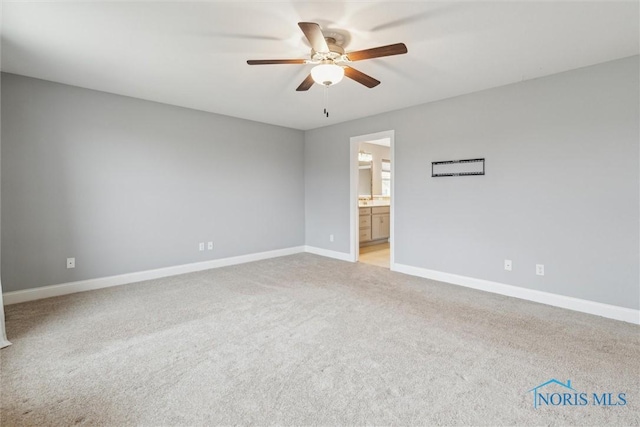 empty room featuring light carpet, ceiling fan, and baseboards