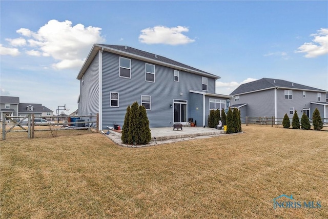 rear view of property featuring a patio area, a fenced backyard, and a lawn