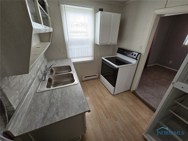 kitchen featuring a healthy amount of sunlight, a baseboard heating unit, a sink, and electric range oven