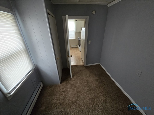 corridor featuring baseboard heating, a baseboard radiator, and carpet floors