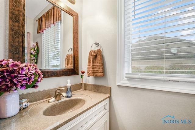 bathroom with plenty of natural light and vanity