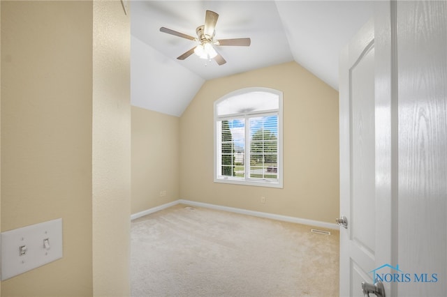 additional living space featuring vaulted ceiling, carpet flooring, a ceiling fan, and baseboards