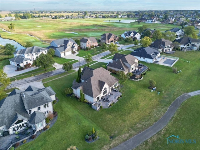 drone / aerial view with a residential view and golf course view