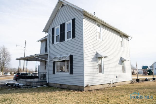 view of side of home featuring a lawn