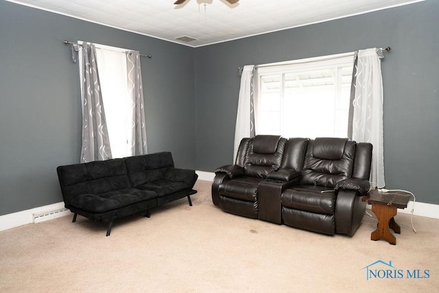 carpeted living room with a ceiling fan and baseboards