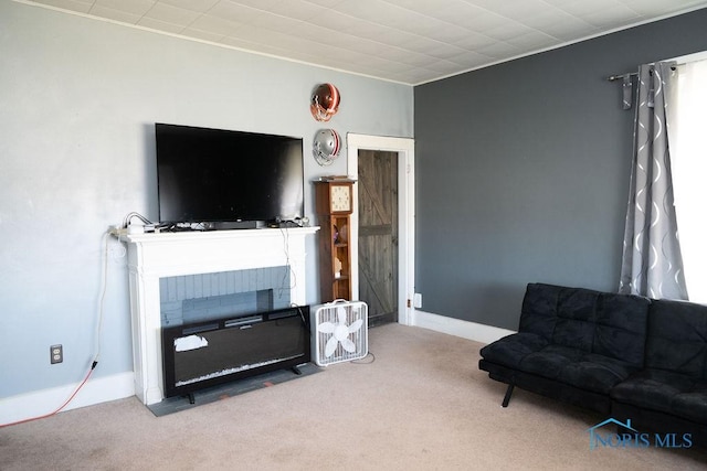 carpeted living area with a fireplace and baseboards