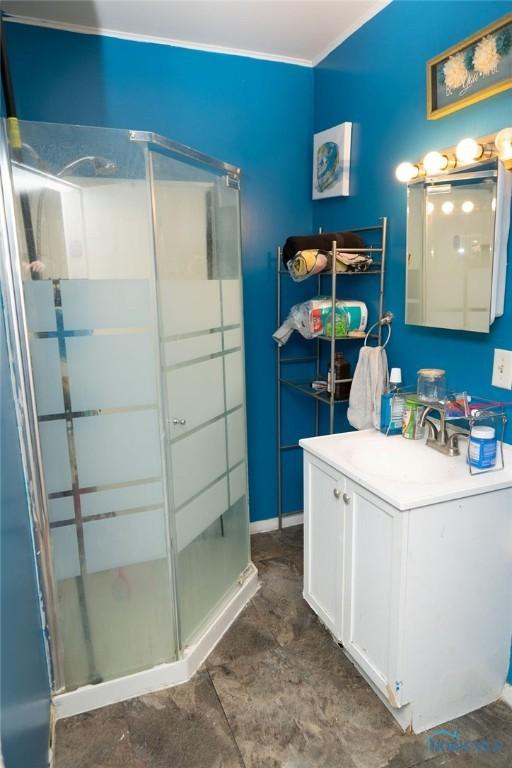 bathroom with a shower stall and vanity