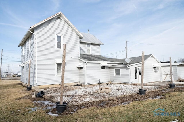 back of property featuring a storage shed and an outbuilding