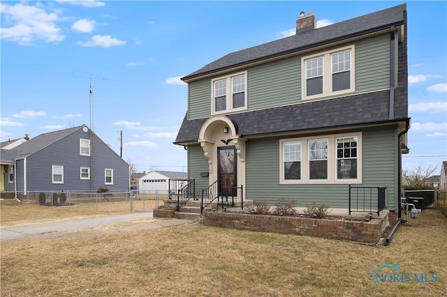 view of front of property featuring a front lawn, a chimney, a shingled roof, and fence