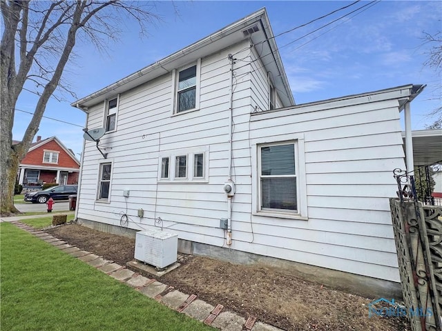 rear view of house featuring a yard