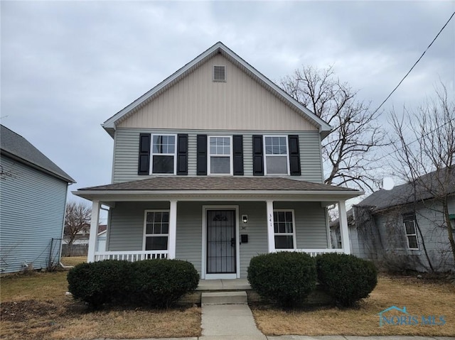 view of front of property with a porch and a shingled roof