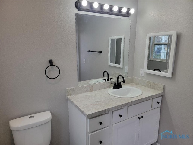 half bath with vanity and toilet