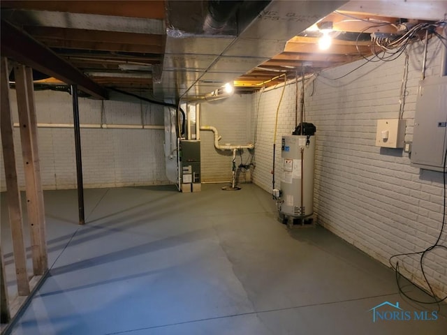 unfinished basement featuring heating unit, brick wall, electric panel, and gas water heater