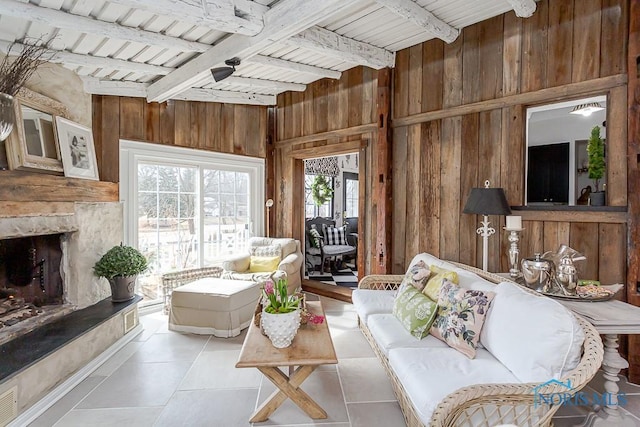 living room with wooden ceiling, wood walls, and a large fireplace