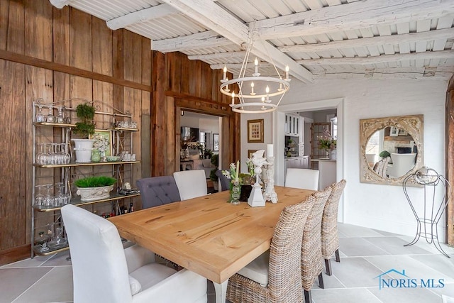 dining room with vaulted ceiling with beams, wood walls, wood ceiling, and a chandelier