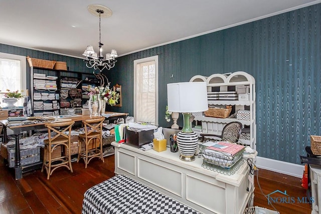 office featuring an inviting chandelier, ornamental molding, wood finished floors, plenty of natural light, and wallpapered walls