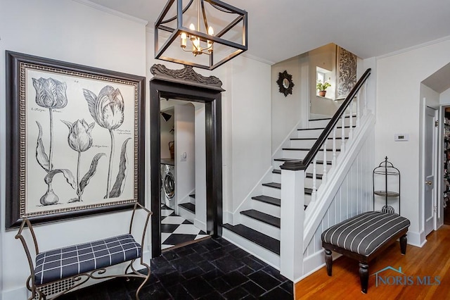 stairs with washer / dryer, baseboards, arched walkways, ornamental molding, and wood finished floors