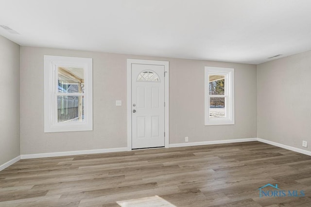 entrance foyer with visible vents, baseboards, and wood finished floors