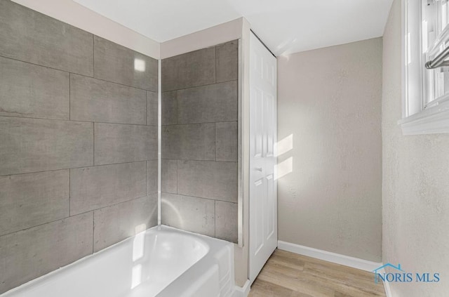5728 Rudyard Rd, Sylvania, OH 43560 - bathroom featuring baseboards, a washtub, and wood finished floors