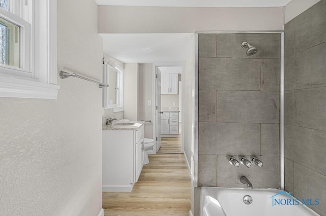 5728 Rudyard Rd, Sylvania, OH 43560 - full bath featuring toilet, shower / bathtub combination, vanity, and wood finished floors