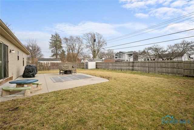 view of yard featuring a patio area, an outdoor structure, a fenced backyard, and a shed