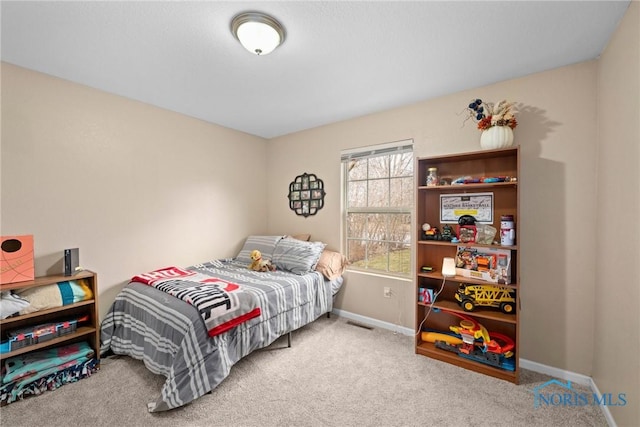 bedroom featuring carpet floors, visible vents, and baseboards