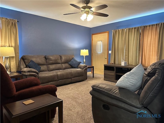 living area featuring carpet and ceiling fan