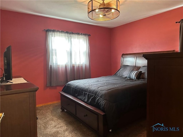 carpeted bedroom featuring a chandelier