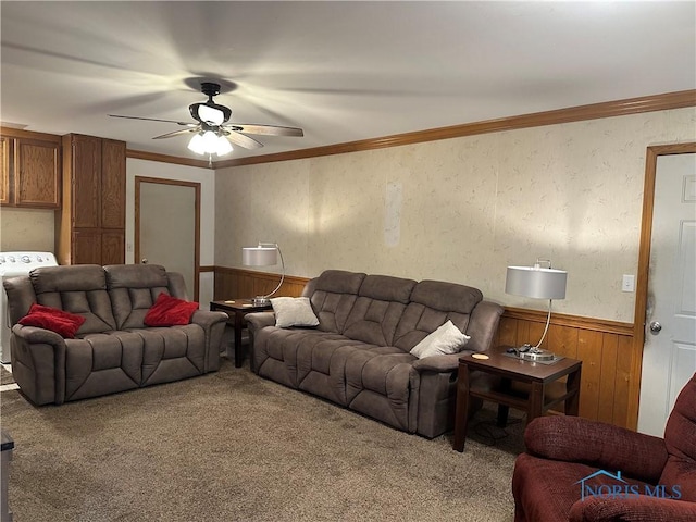 carpeted living room featuring ornamental molding, washer / dryer, and wainscoting