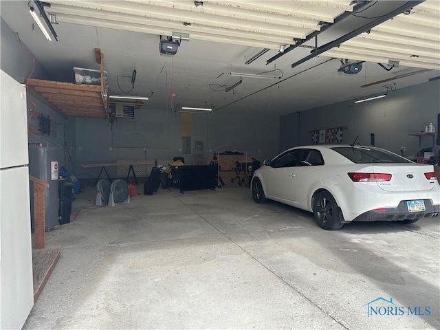 garage featuring water heater and a garage door opener